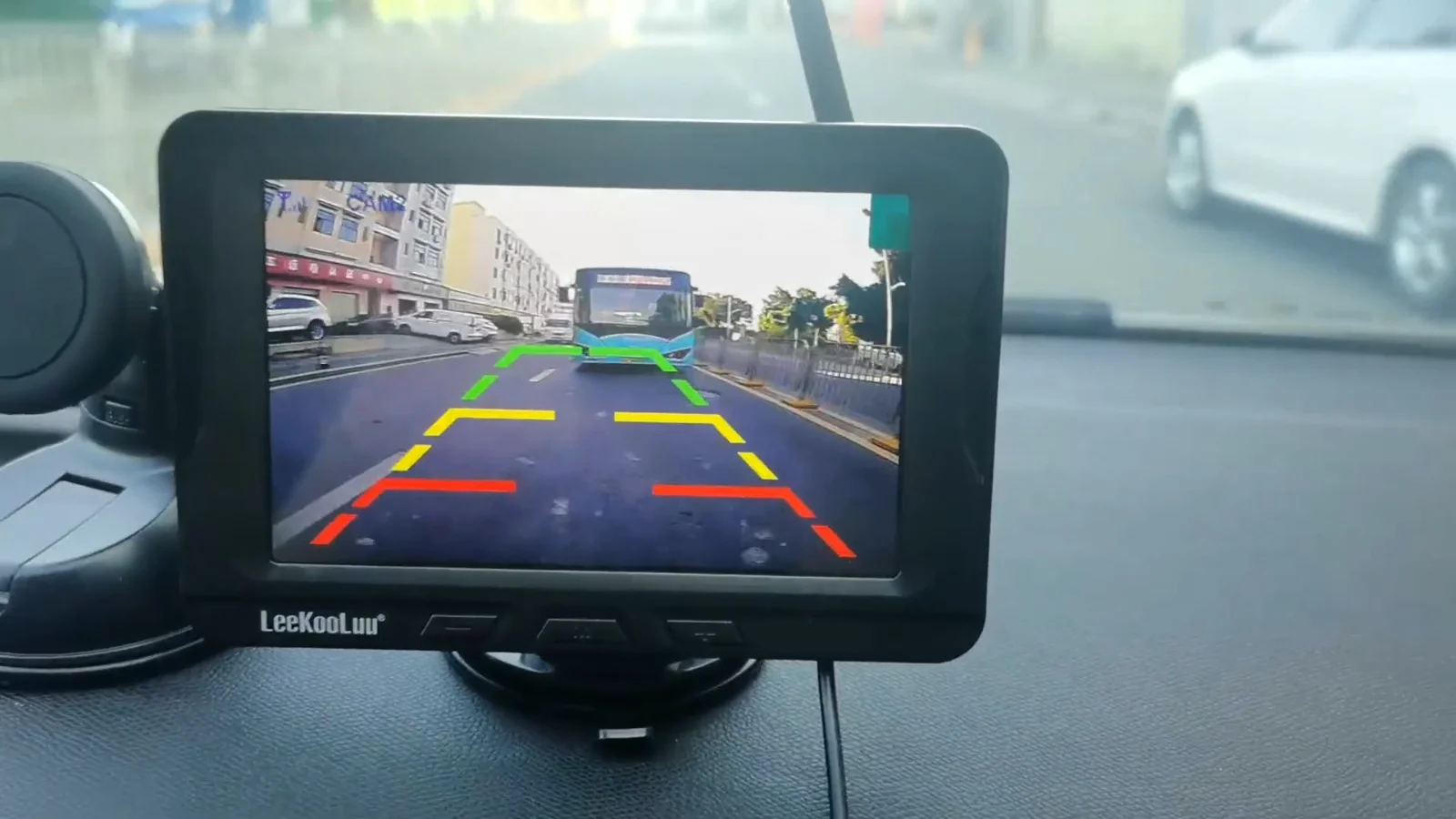A dash monitor showing the street behind the car